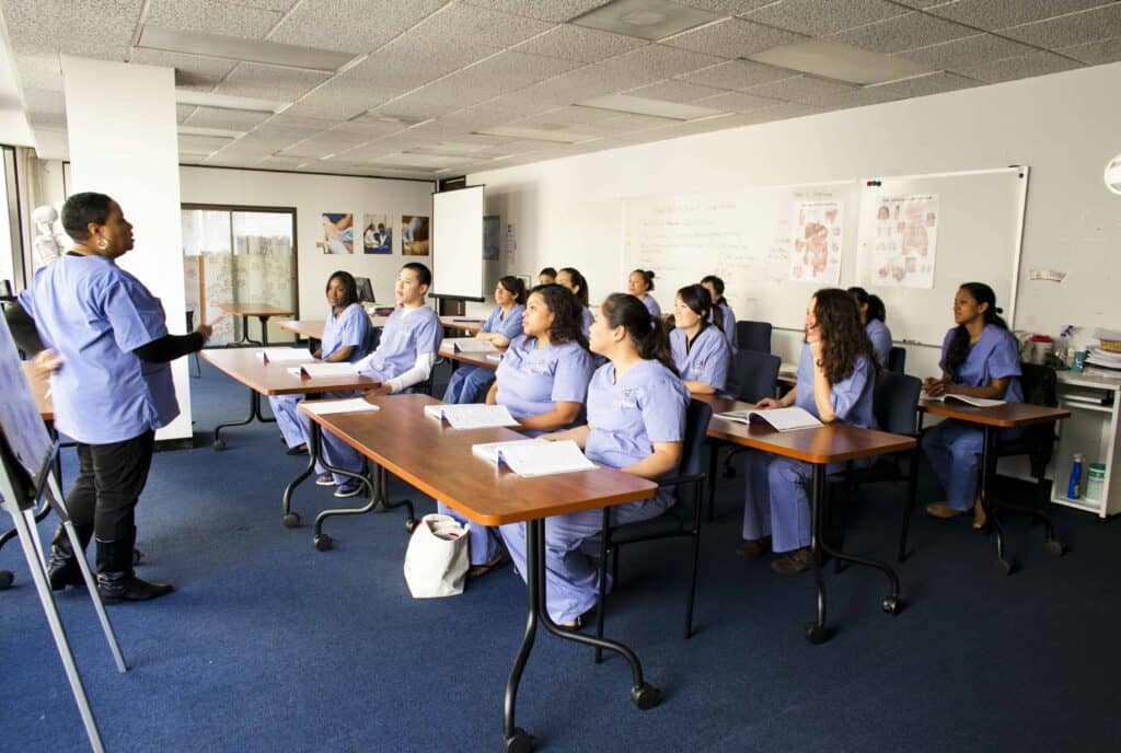 A group of medical assistants from the Bay area are being trained in a classroom.