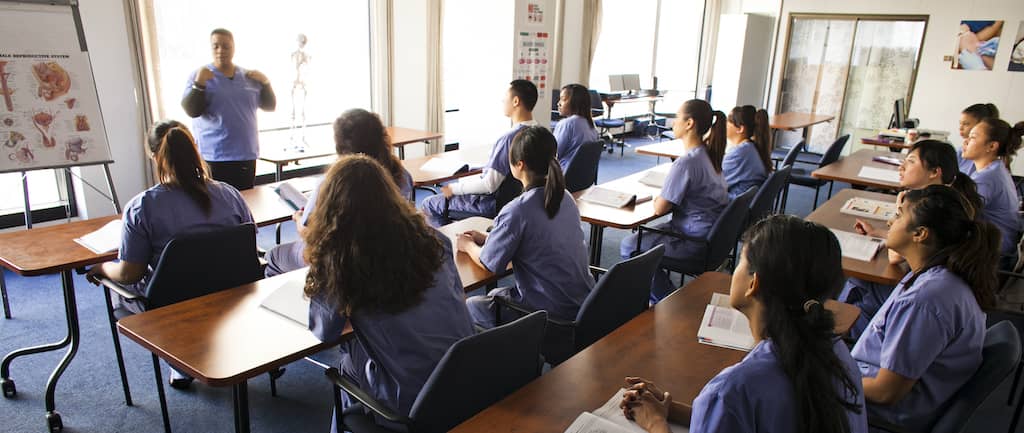 A classroom full of medical assistants in training preparing for their job interview.