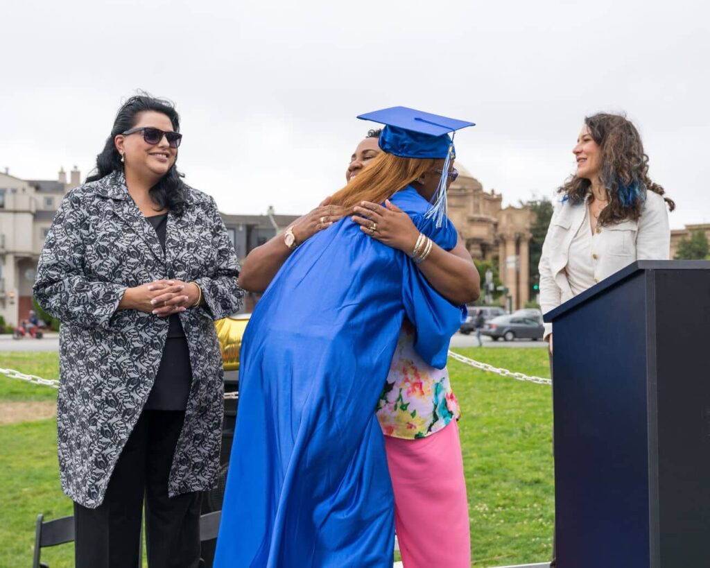 Graduate being congratulated by family and friends at the Bay Medical Academy Graduation ceremony.